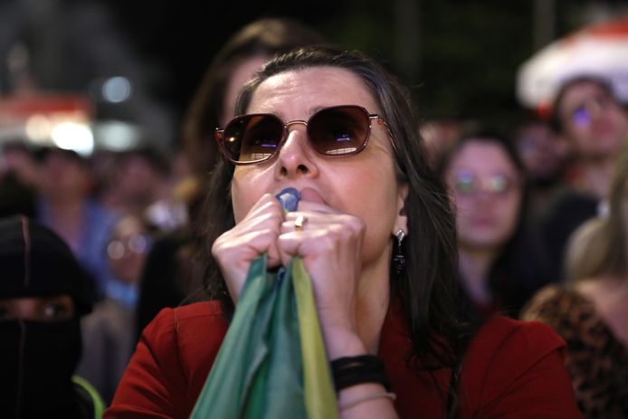 A Lula supporter is anxiously watching the results of the elections in São Paulo.
