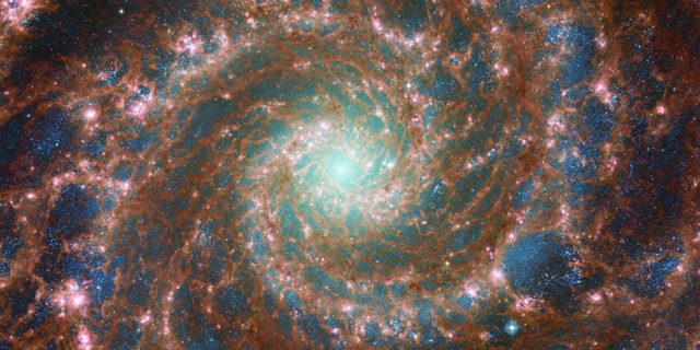 M74 shines brightly in this infrared/medium infrared composite image, which includes data from the NASA/ESA Hubble Space Telescope and the NASA/ESA/CSA James Webb Space Telescope.  This image has incredible depth thanks to Hubble's Advanced Camera for Surveys (ACS) and the web's powerful mid-infrared (MIRI) instrument that captures a range of wavelengths. 