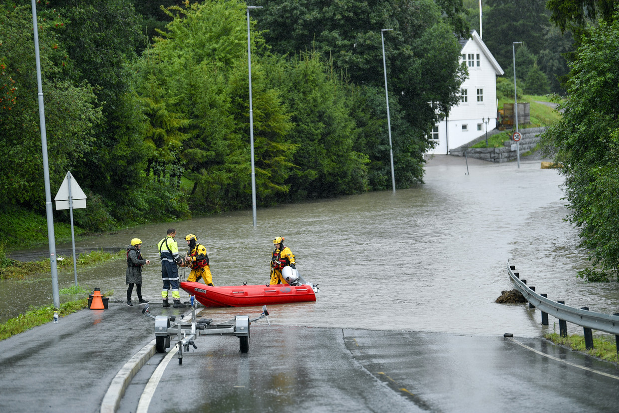 Nurse Ingrid Marie Nyborg (left) gets help from members of the rescue team to go to work in Oslo, Norway.  ANP/EPA image