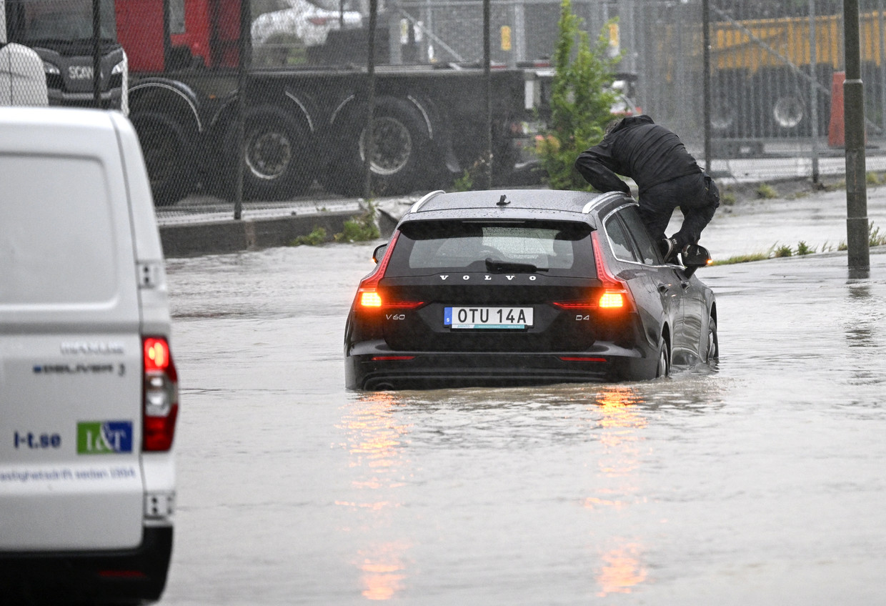     A man gets out of a submerged car in Arlov, near Malmö, Sweden.  ANP/EPA image