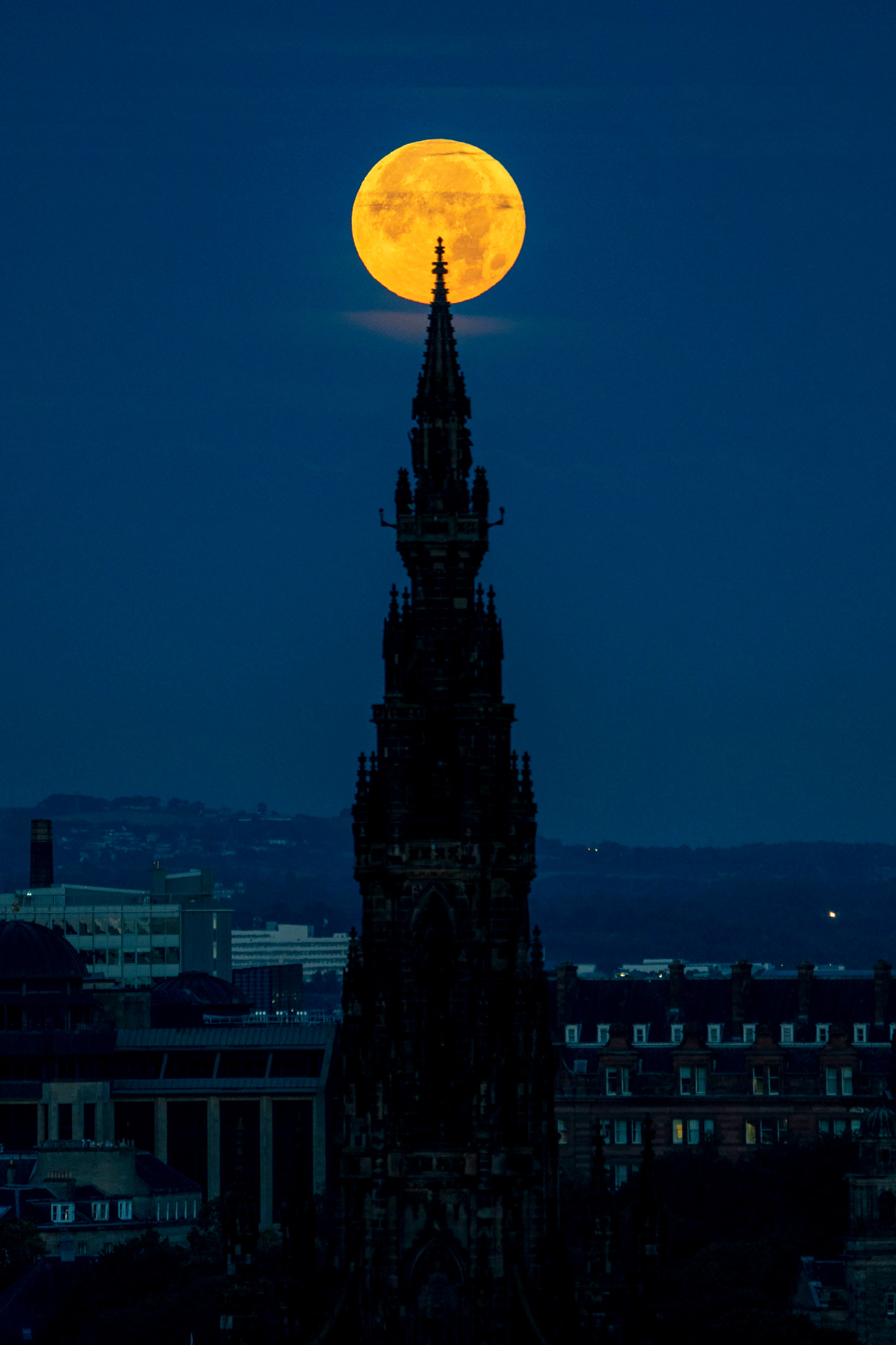 The moon is pictured with the Scott Memorial in Edinburgh, Scotland.  ap image