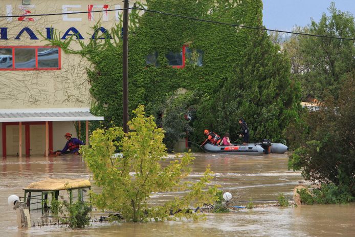 Firefighters rescue people in a flooded area in Larissa.