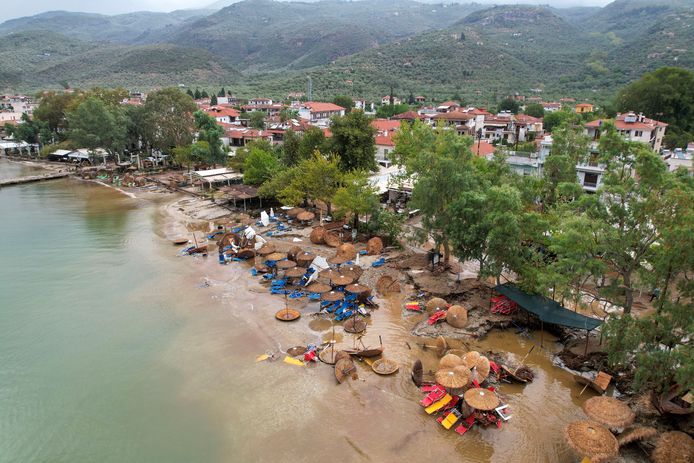 Broken sun loungers and umbrellas after flood waters are returned to the sea at Cala Nera.