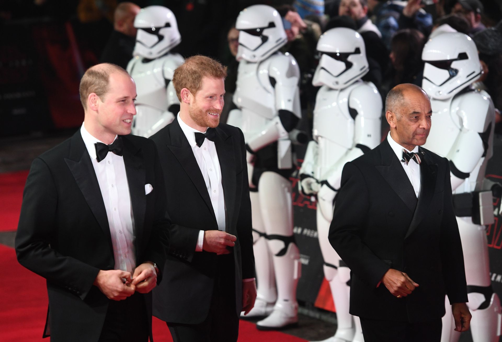 Prince William and Prince Harry walk past some Stormtroopers.