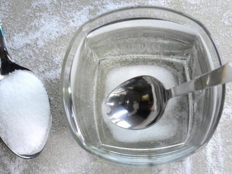 Gargling with salt water to treat sore throat and cough